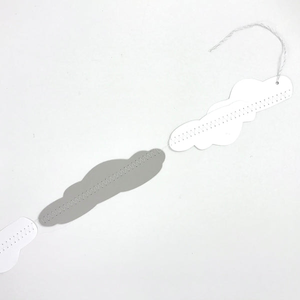 A close up look at the end of the cloud garland, showing some white and silver string on the end of the garland to assist with hanging.  The garland is shown against a white background