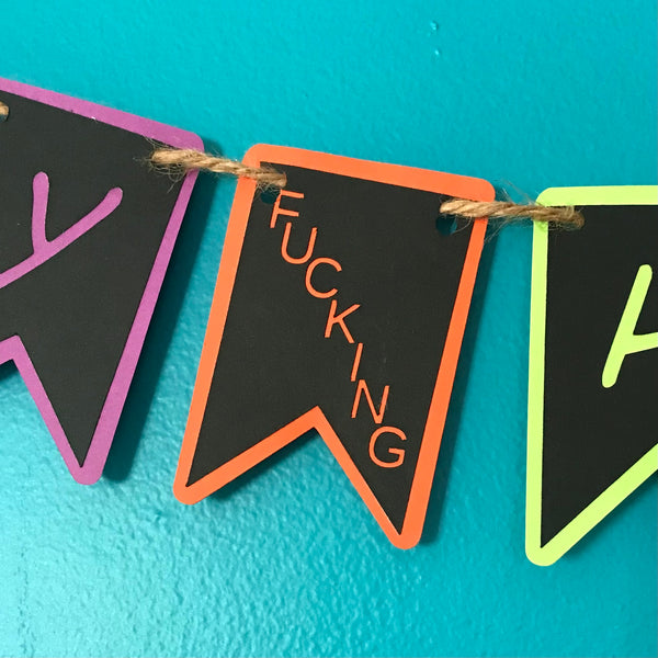 a close up of the little letter tab that reads "fucking" which is hung between the words Happy and Halloween on this adult humour banner