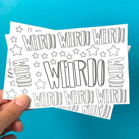 a hand holds up two sheets of black and white WEIRDO stickers against a blue background.