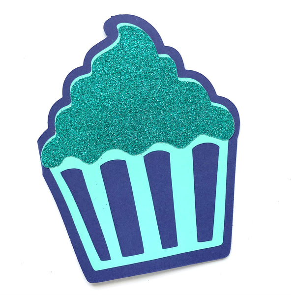 A cupcake shaped card in shades of blue is shown against a white background