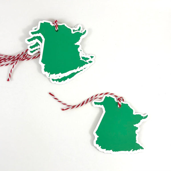 5 gift tags in the shape of the province of New Brunswick are shown against a white background; four are stacked together in the top left corner, with one in the bottom right corner of the image