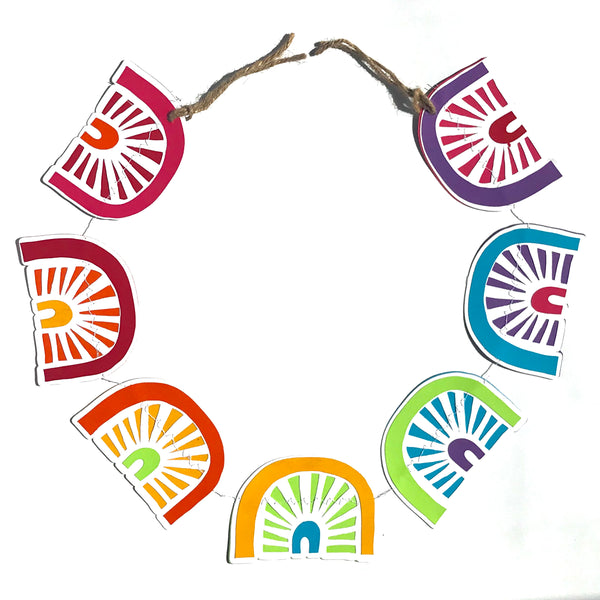 a garland of 7 rainbows is shown forming a circle against a white background.  the garland has hemp on the end.